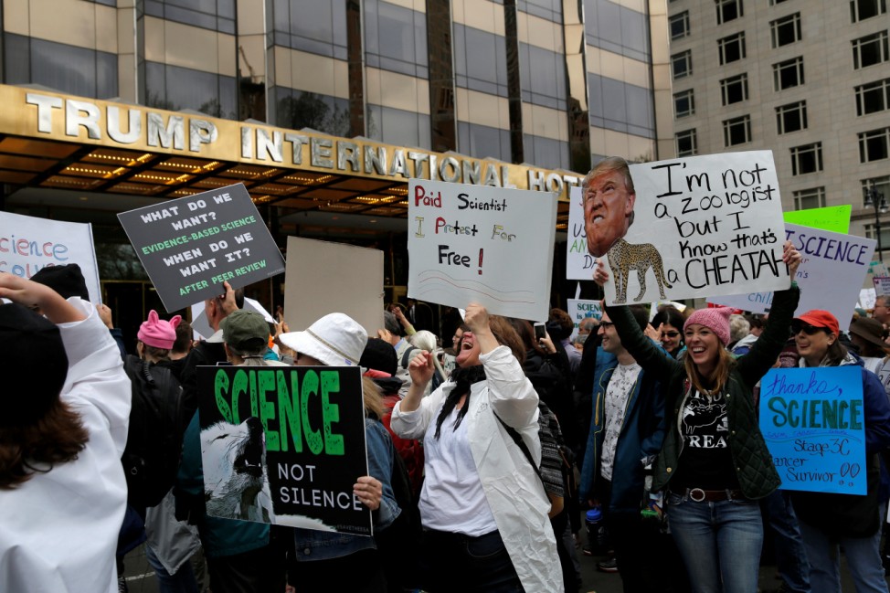 People walk past Trump International Hotel and Tower during the Earth Day 'March For Science NYC' demonstration to coincide with similar marches globally in Manhattan, New York, U.S.