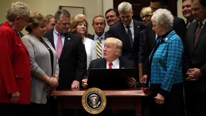 U.S. President Donald Trump prepares to sign an executive order on education during an event with Governors at the White House in Washington