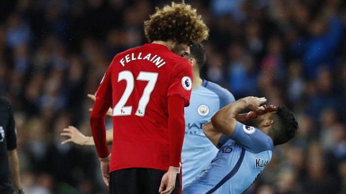 Manchester United's Marouane Fellaini clashes with Manchester City's Sergio Aguero before being sent off by referee Martin Atkinson
