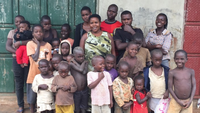 Uganda: Familienaufstellung, nicht vollständig: Mariam (mittig, grünes Kleid) sagt, eigentlich wollte sie nur sechs Kinder.
