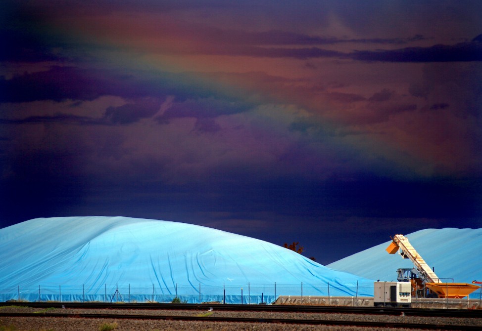 Piles of harvested wheat are covered with plastic sheets near the depot for GrainCorp, Australia's largest listed bulk grain handler, located in the New South Wales town of Burren Junction, located north-west of Sydney in Australia