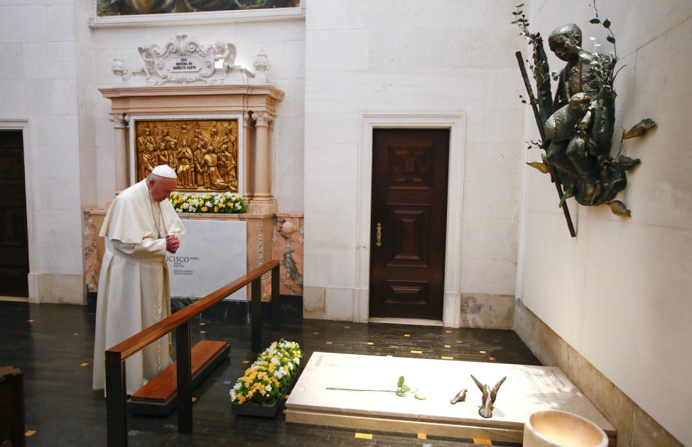 Pope Francis prays on the grave of one of the three little sheperd at the Shrine of Our Lady of Fatima in Portugal