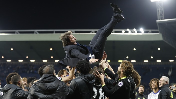 Chelsea manager Antonio Conte is thrown in the air by his players as they celebrate winning the Premier League title