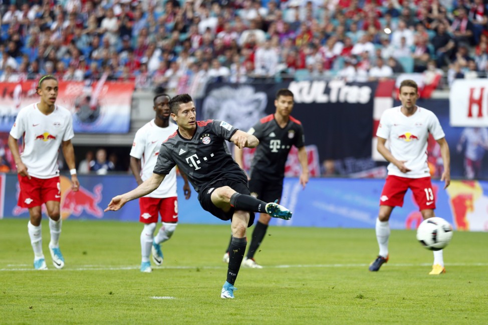 Bayern Munich's Robert Lewandowski scores their first goal from the penalty spot