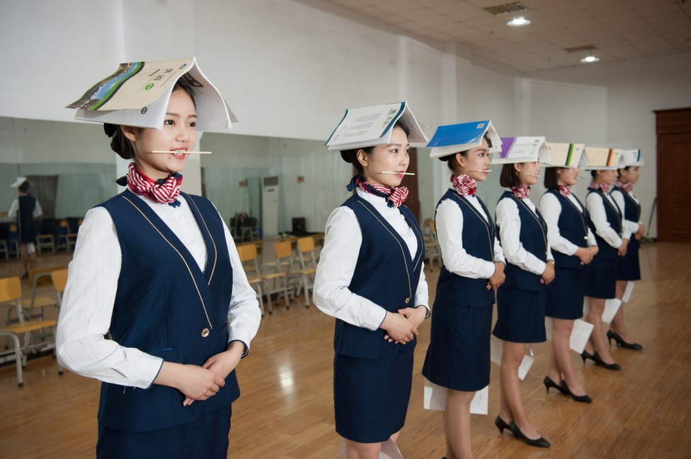 Students training to be flight attendants take part in a standing posture practice at a vocational school in Shijiazhuang