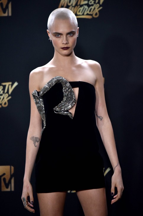 Actress Cara Delevingne attends the MTV Movie & TV Awards in the rain at the Shrine Auditorium in Lo