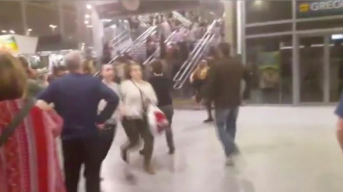 People running down stairs as they attempt to exit the Manchester Arena after a blast, where U.S. singer Ariana Grande had been performing, in Manchester, Britain in this still image taken from video