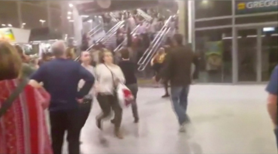 People running down stairs as they attempt to exit the Manchester Arena after a blast, where U.S. singer Ariana Grande had been performing, in Manchester, Britain in this still image taken from video