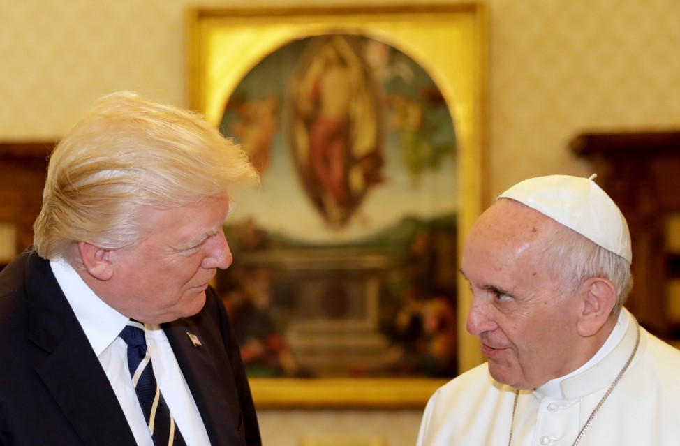 Pope Francis talks with U.S. President Donald Trump during a private audience at the Vatican