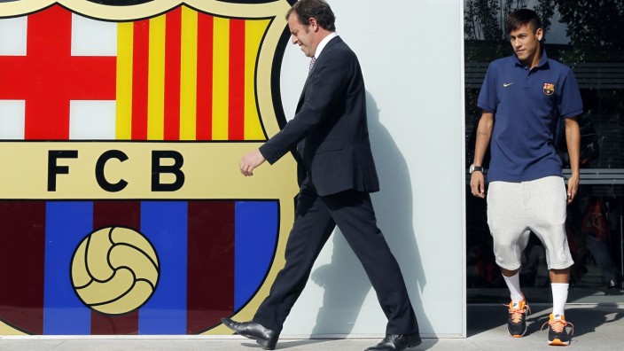 Neymar and Barcelona's president Sandro Rosell walk out to meet the media, after Neymar signed a five-year contract with FC Barcelona, at their offices close to Camp Nou stadium in Barcelona