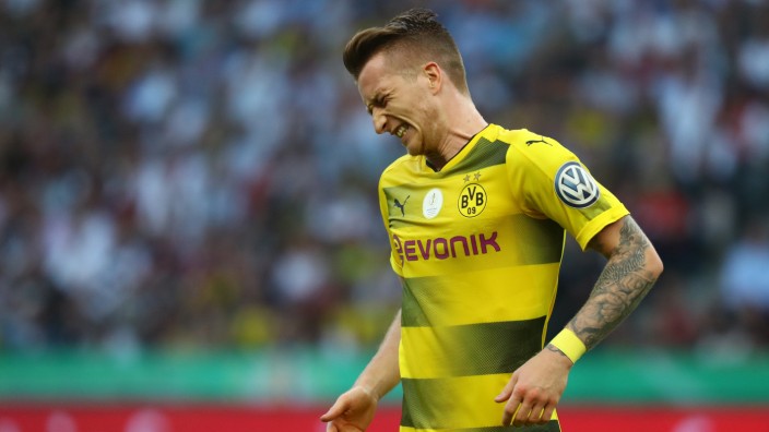 Borussia Dortmund's Marco Reus reacts after sustaining an injury