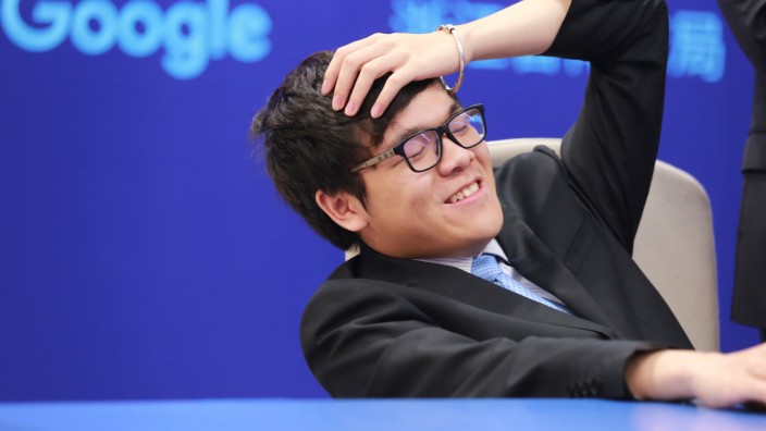 Chinese Go player Ke Jie reacts during his second match against Google's artificial intelligence program AlphaGo at the Future of Go Summit in Wuzhen