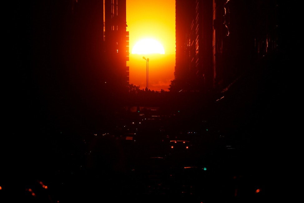 The sun sets while lined up with 42nd Ave a few days after the Manhattanhenge phenomenon in the Manhattan borough of New York City