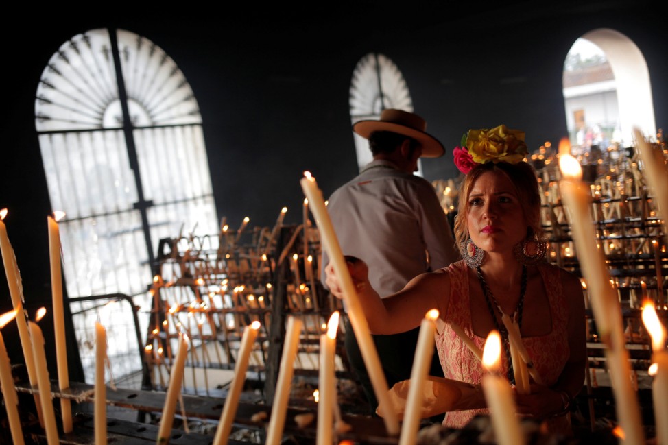 Pilgrims light candles during a pilgrimage in the shrine of El Rocio in Almonte