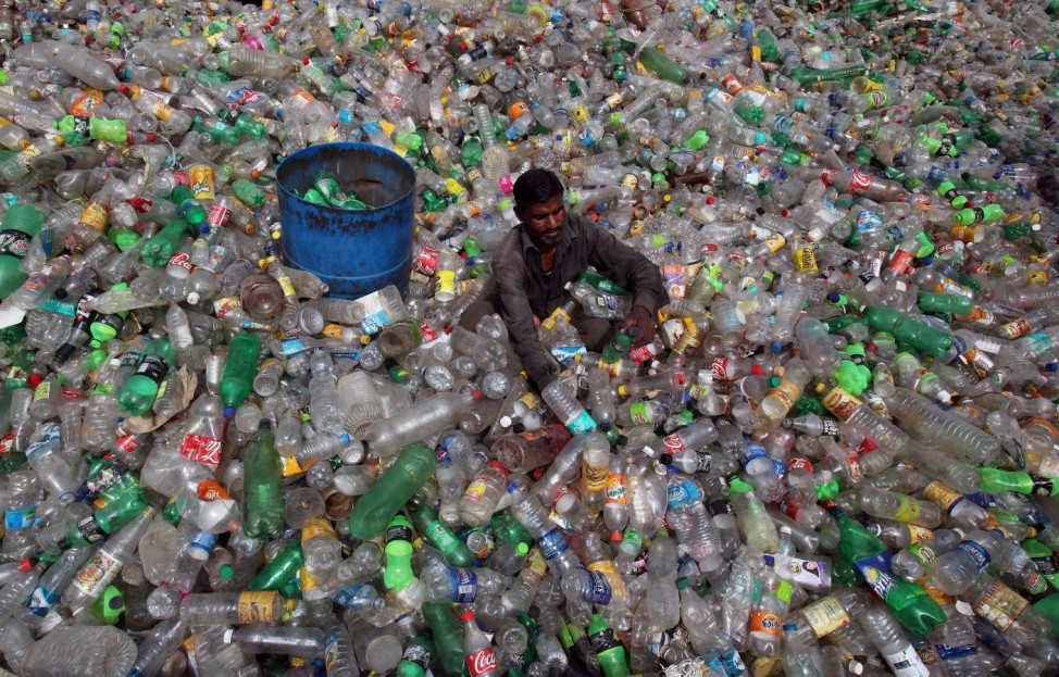 A man sorts bottles at a plastic junkyard on World Environment Day, in Chandigarh