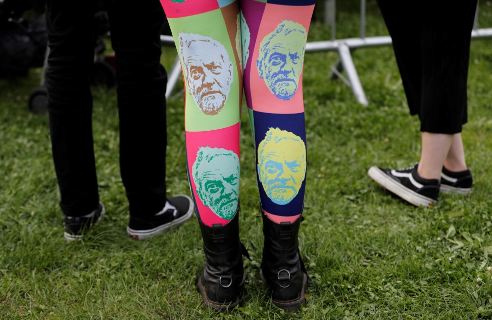 A woman wears tights showing the face of Jeremy Corbyn, leader of Britain's opposition Labour Party, at a campaign rally in Birmingham