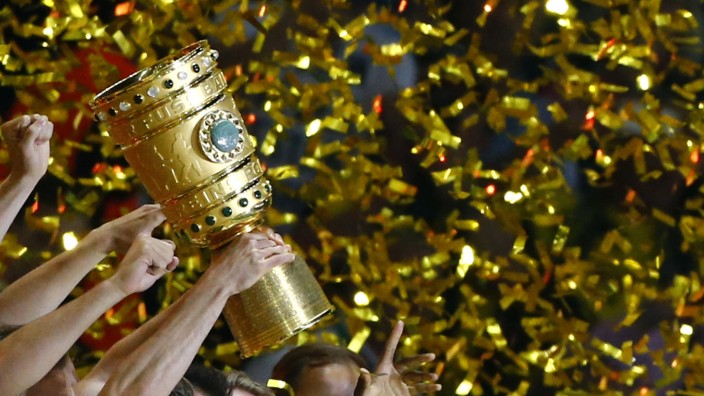 Borussia Dortmund players lift the trophy as they celebrate after victory