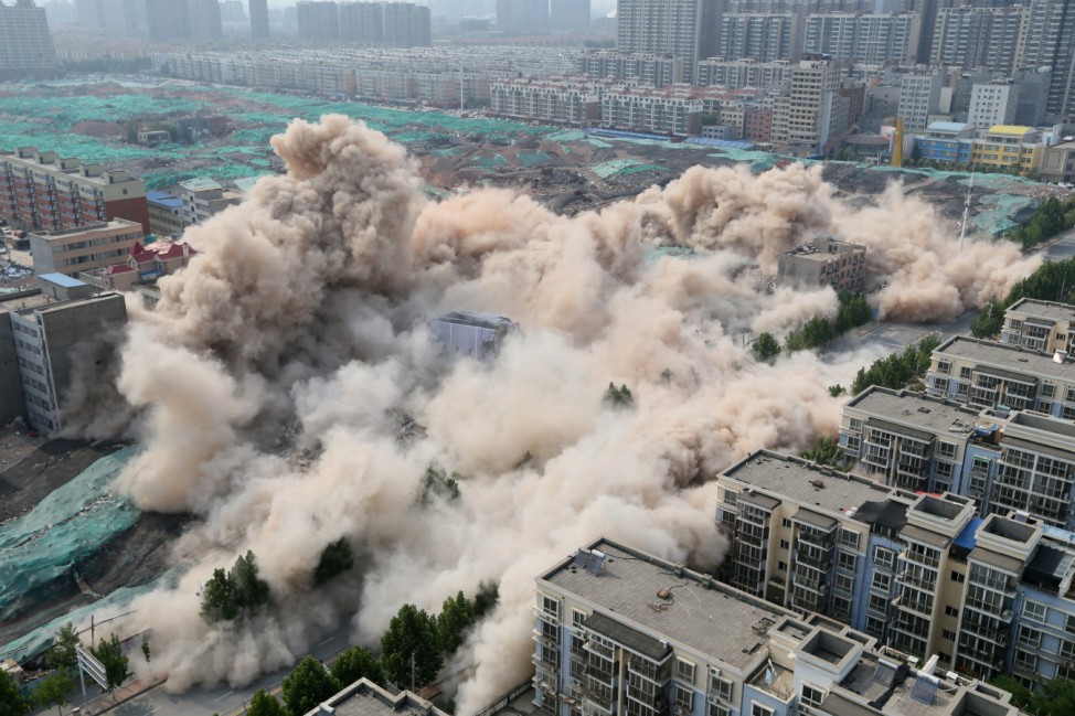 Buildings crumble during a controlled demolition for the reconstruction of urban villages in Zhengzhou