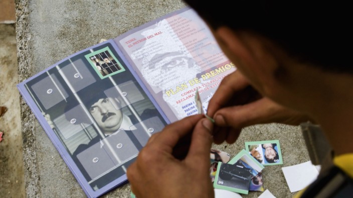 Child pastes stickers of Pablo Escobar in an album that is sold in stores in Medellin