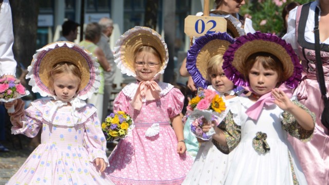 Freiwillige dringend gesucht: Beim traditionellen Dachauer Kinderfestzug treten auch die kleinsten Damen elegant auf wie hier in Kleidern des Biedermeier.