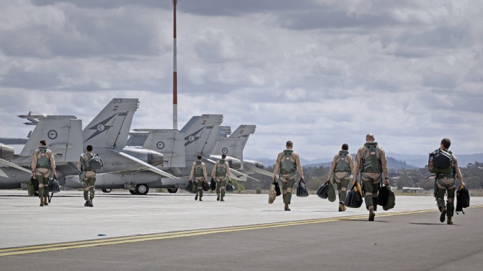 Crew members of Royal Australian Air Force F/A-18F Super Hornets prepare to take-off from RAAF Base Amberley in Queensland
