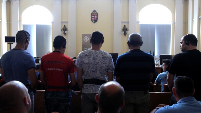 Defendants stand in the court room, ahead of the trial in which they are charged with causing the death of 71 migrants who suffocated in a lorry found beside an Austrian motorway in 2015, in Kecskemet