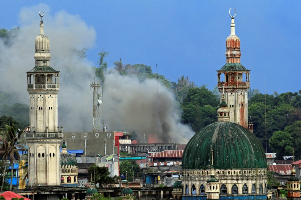 Smoke billows are seen as government troops continue their assault against insurgents from the Maute group, who have taken over parts of Marawi city