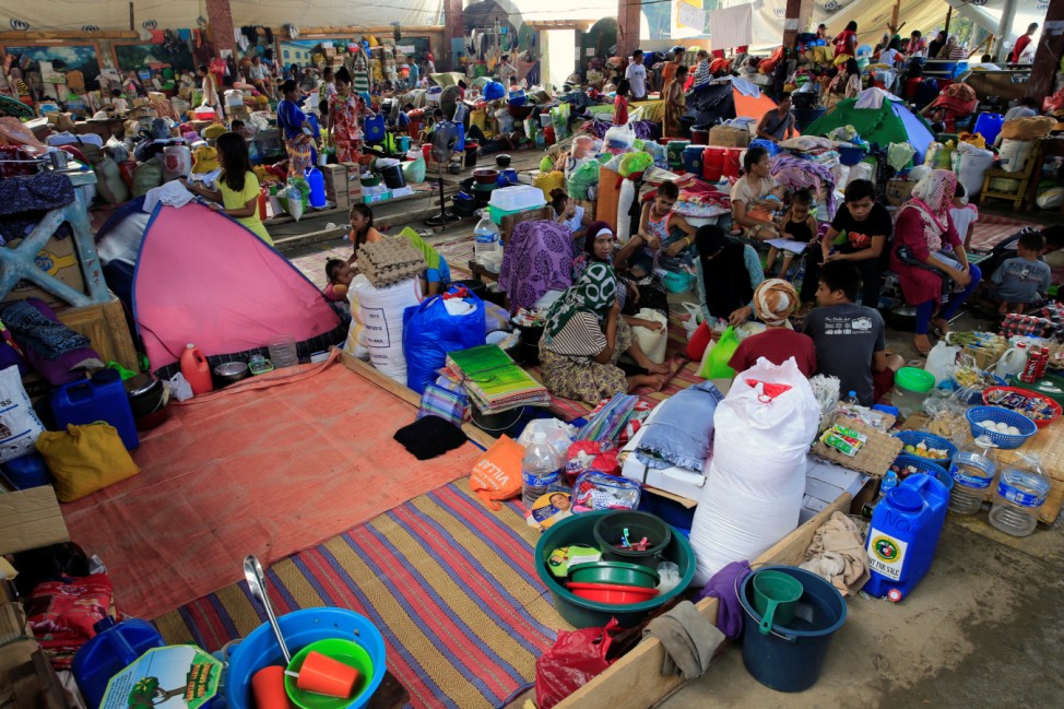 Residents who left their homes to avoid the intense fighting between the government forces and insurgents from the Maute group are seen inside the evacuation centre in Iligan city
