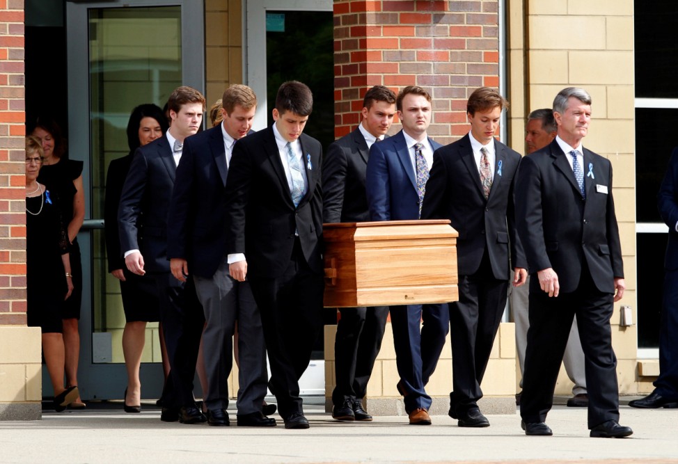 The casket of Otto Warmbier is carried to the hearse followed by his family and friends after a funeral service for Warmbier, who died after his release from North Korea, at Wyoming High School in Wyoming
