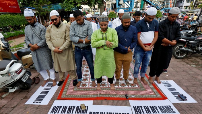 Muslims offer prayers as they take part in a protest in Kolkata