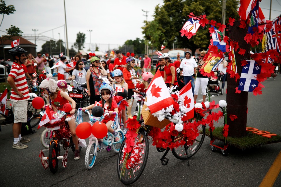 Children prepare to participate in the East York Toronto Canada Day parade in Toronto