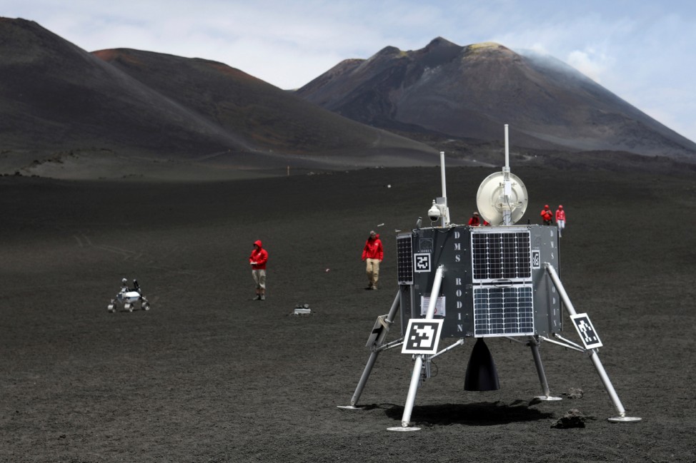 Scientists from German Aerospace Center are seen working as they test some robots on the Mount Etna