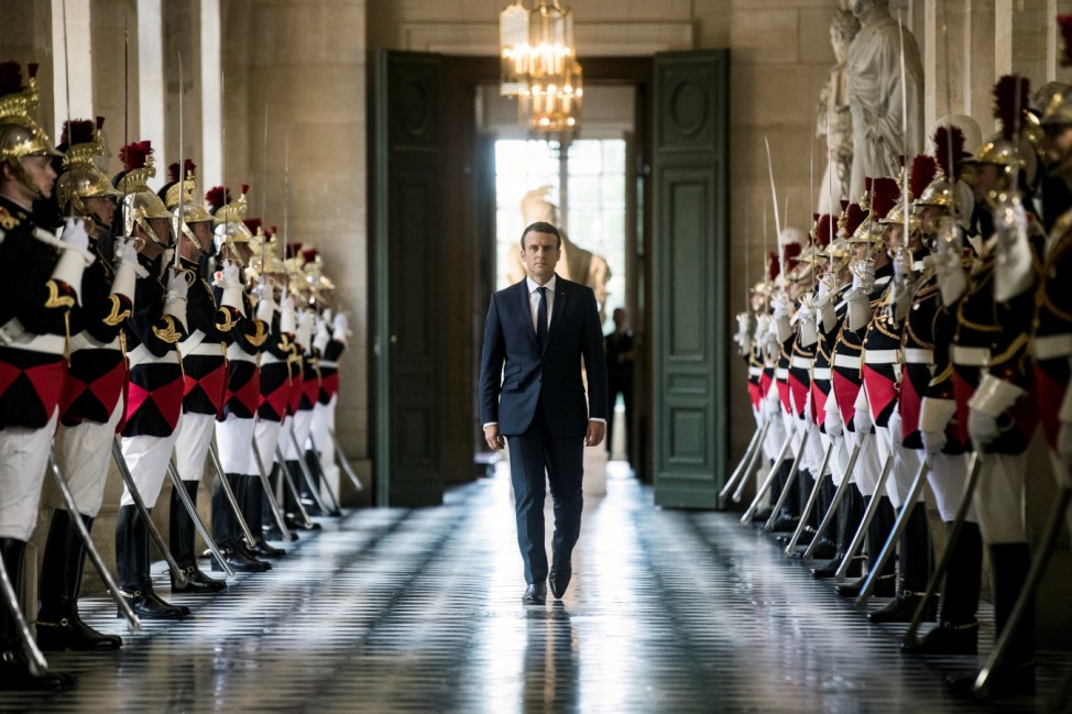 French President Emmanuel Macron  walks through the Galerie des Bustes (Busts Gallery) to access the Versailles Palace's hemicycle for a special congress gathering both houses of parliament near Paris