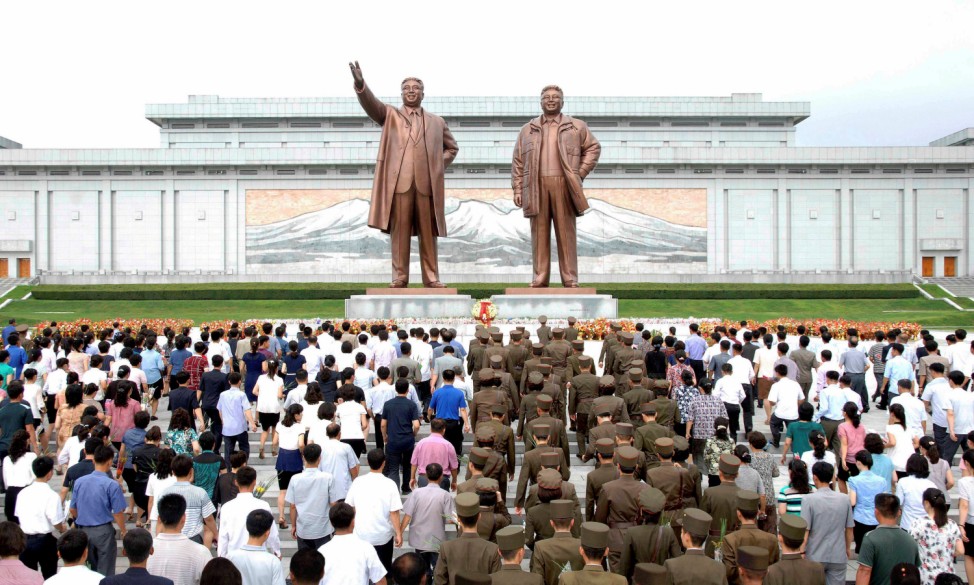 People gather to mark the occasion of the 23rd anniversary of the demise of the country's founding father Kim Il Sung