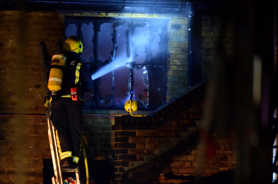 A firefighter tackles a fire at Camden Market in north London