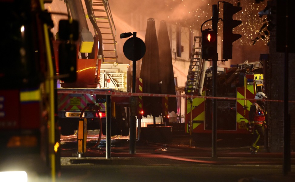 A firefighter walks near a fire at Camden Market in north London