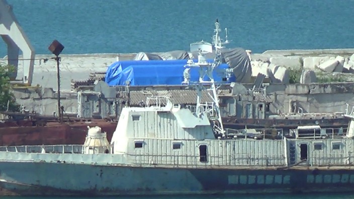 A still image taken from a video footage shows blue tarpaulins covering equipment at the port of Feodosia