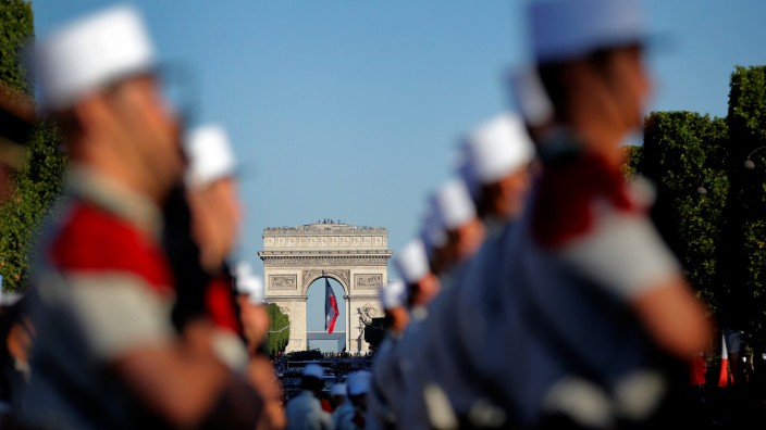 Soldiers of the French Foreign Legion are seen prior to the start of the traditional Bastille day military parade on the Champs-Elysees  with the Arc de Triomphe in the background in Paris