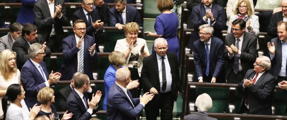 Law and Justice party leader Jaroslaw Kaczynski enters the parliament as his party members applause in Warsaw