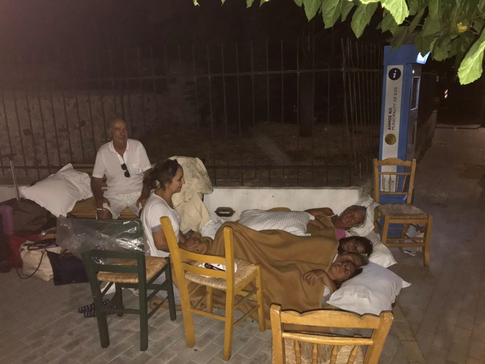 People sleep in the street after a quake in Kos