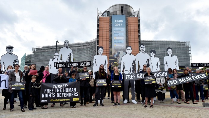 Amnesty International activists hold a protest outside the EU commission with giant figures depicting activists who were detained in Turkey, in Brussels