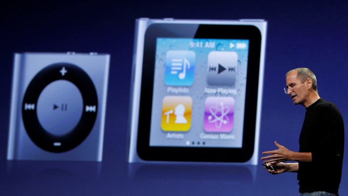 FILE PHOTO: Apple CEO Jobs speaks on stage with images of the iPod Shuffle and iPod Nano projected on screen at Apple's music-themed September media event in San Francisco