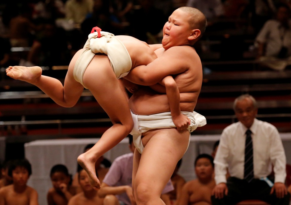 Elementary school sumo wrestlers compete in the sumo ring during the Wanpaku sumo-wrestling tournament in Tokyo