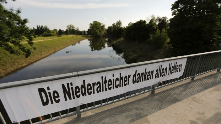 A banner hangs on a bridge over the formerly flooded Ohe river in Niederalteich, after the waters of the nearby Danube and Isar river subsided in the region's worst floods in a decade