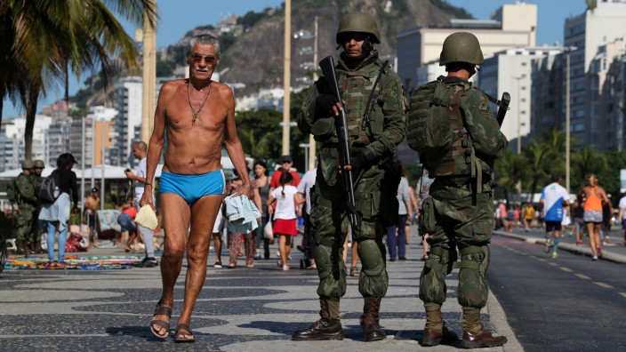 Brazilian navy soldiers patrol the Copacabana beach as part of a plan to combat organized crime in Rio de Janeiro