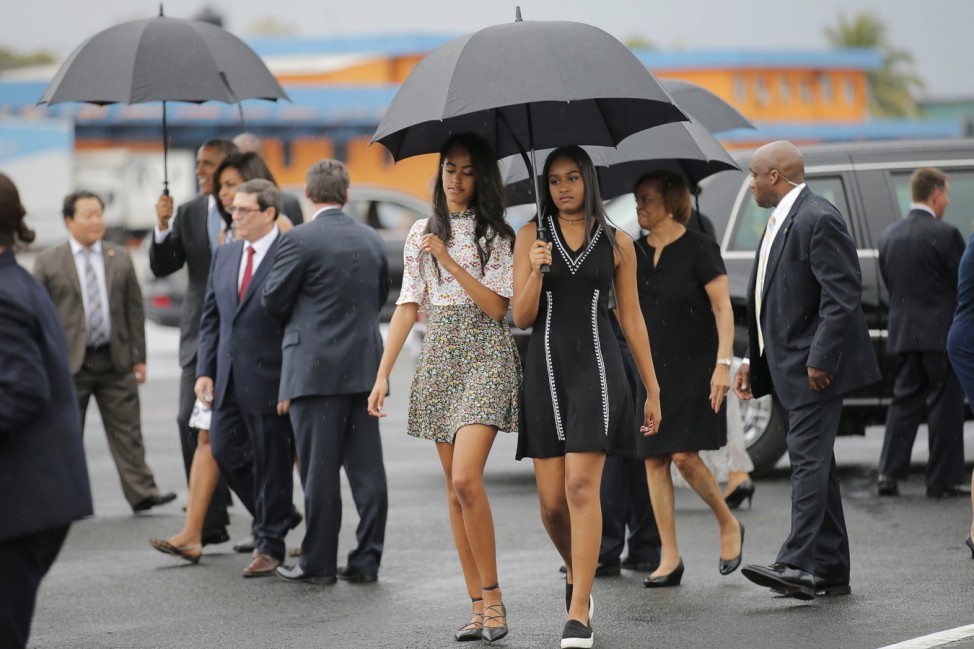 U.S. President Barack Obama's daughters Malia and Sasha arrive with their parents at the Jose Marti international airport at the start of a three-day visit to Cuba, in Havana