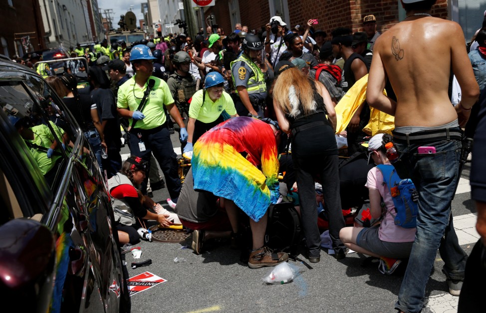 Rescue workers assist people who were injured when a car drove through a group of counter protestors at the 'Unite the Right' rally Charlottesville