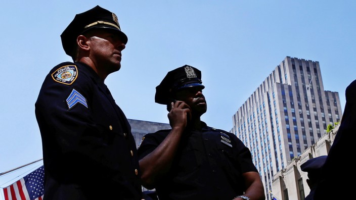 New York Police Department officers stand on 5th Avenue in New York