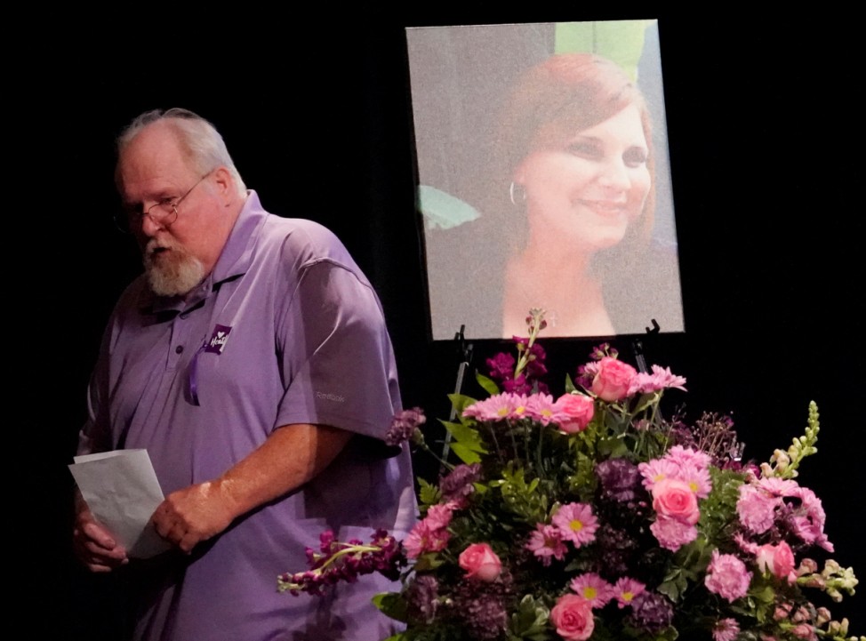 Car attack victim Heather Heyer's father Mark passes picture of his daughter after addressing memorial service in Charlottesville, Virginia