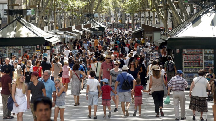 People walk by Las Ramblas in Barcelona
